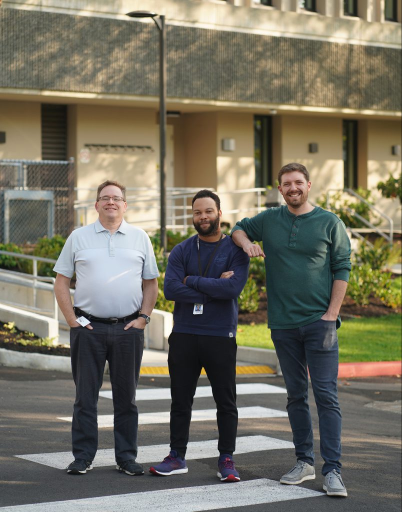 Photo of three members of the Washington State Department of Ecology's toxics reduction program, standing on a corsswalk outside an office building in Shoreline, Washington
