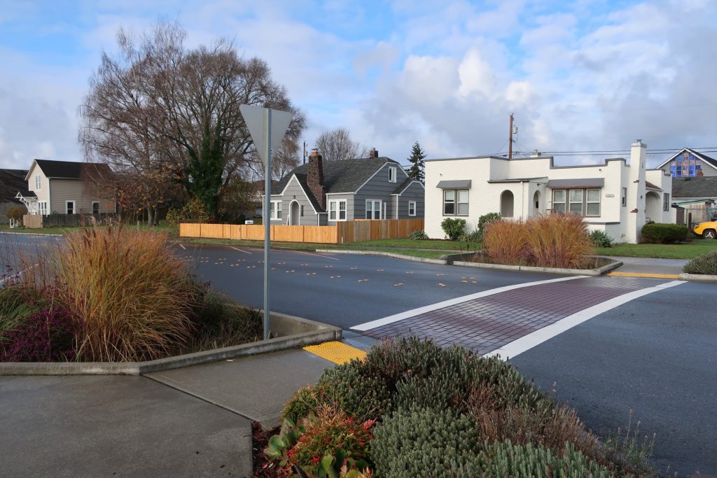 Photo showing an intersection in Marysville, WA, that contains bioretention cells (filled with native plants and other materials) to help treat stormwater runoff.