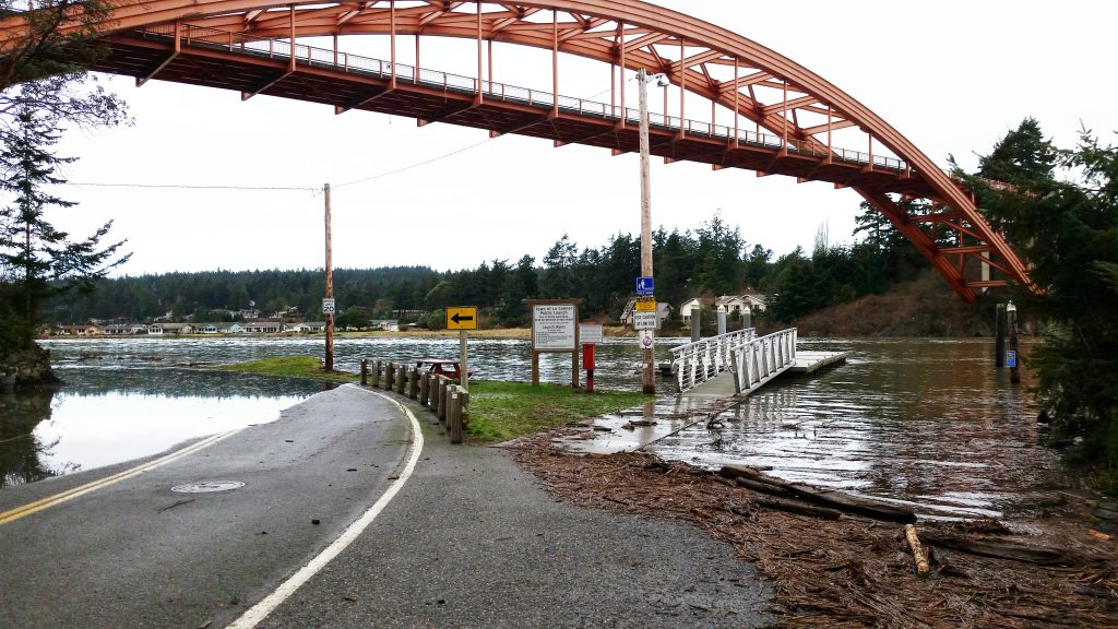 Photo that shows water flooding over a boat launch near La Conner, WA.