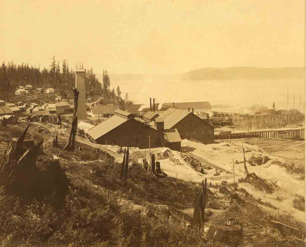 1890s photo of the Tacoma smelter site, showing the smelter buildings on the hills near Commencement Bay.