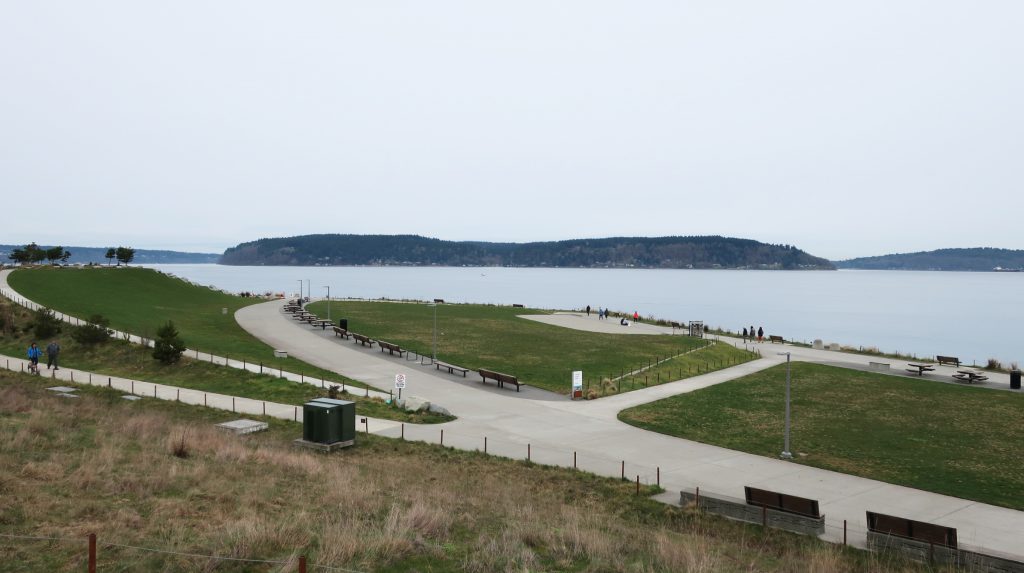 Photo of Dune Peninsula at Point Defiance Park in Tacoma, WA. This photo shows the walking paths in Dune Peninsula Park and a view of Vashon Island across the water.
