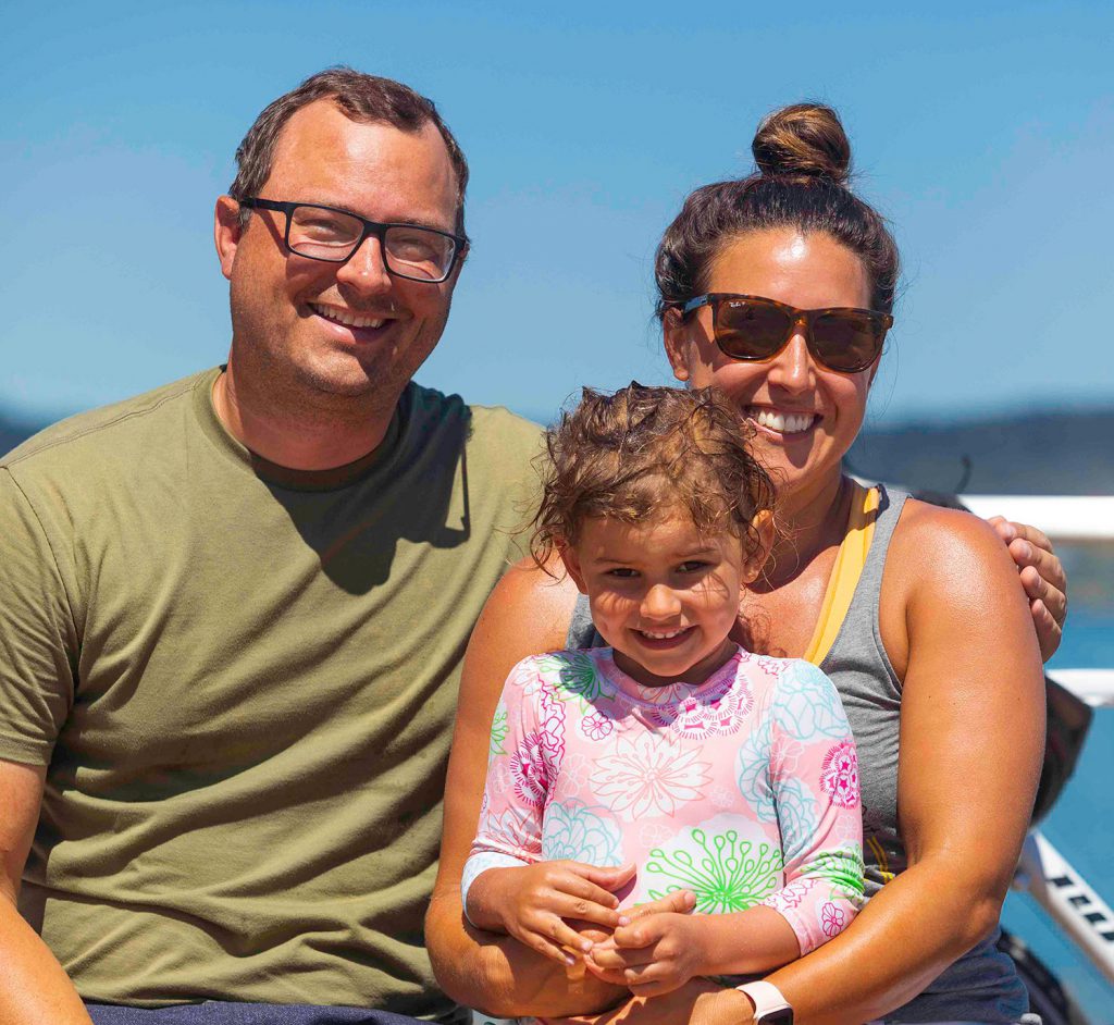 Portrait photo of Steve and Susie Nalivka, with their daughter, at Point Ruston.
