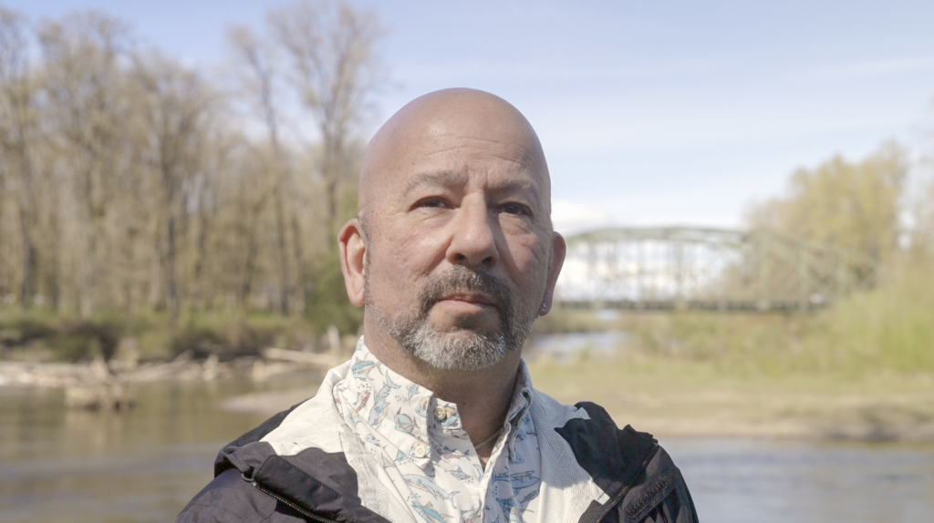 David Troutt, natural resources director for the Nisqually Indian Tribe and chair of the Puget Sound Salmon Recovery Council, standing near the Nisqually River and the I-5 bridge.