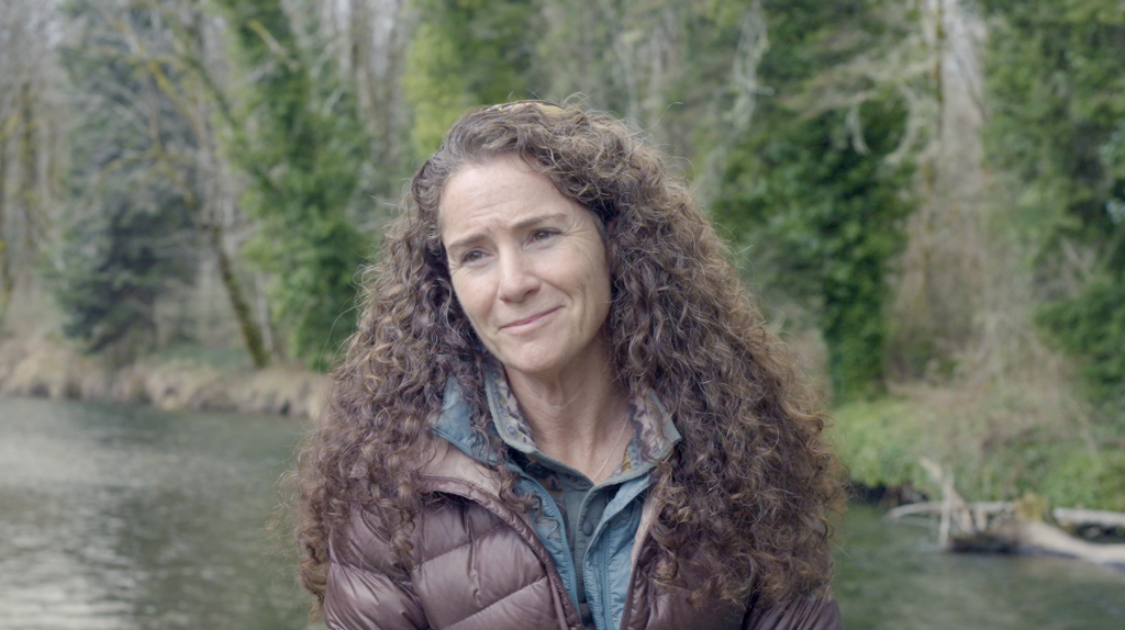 Mendy Harlow, executive director of the Hood Canal Salmon Enhancement Group, sitting near the Big Quilcene River.